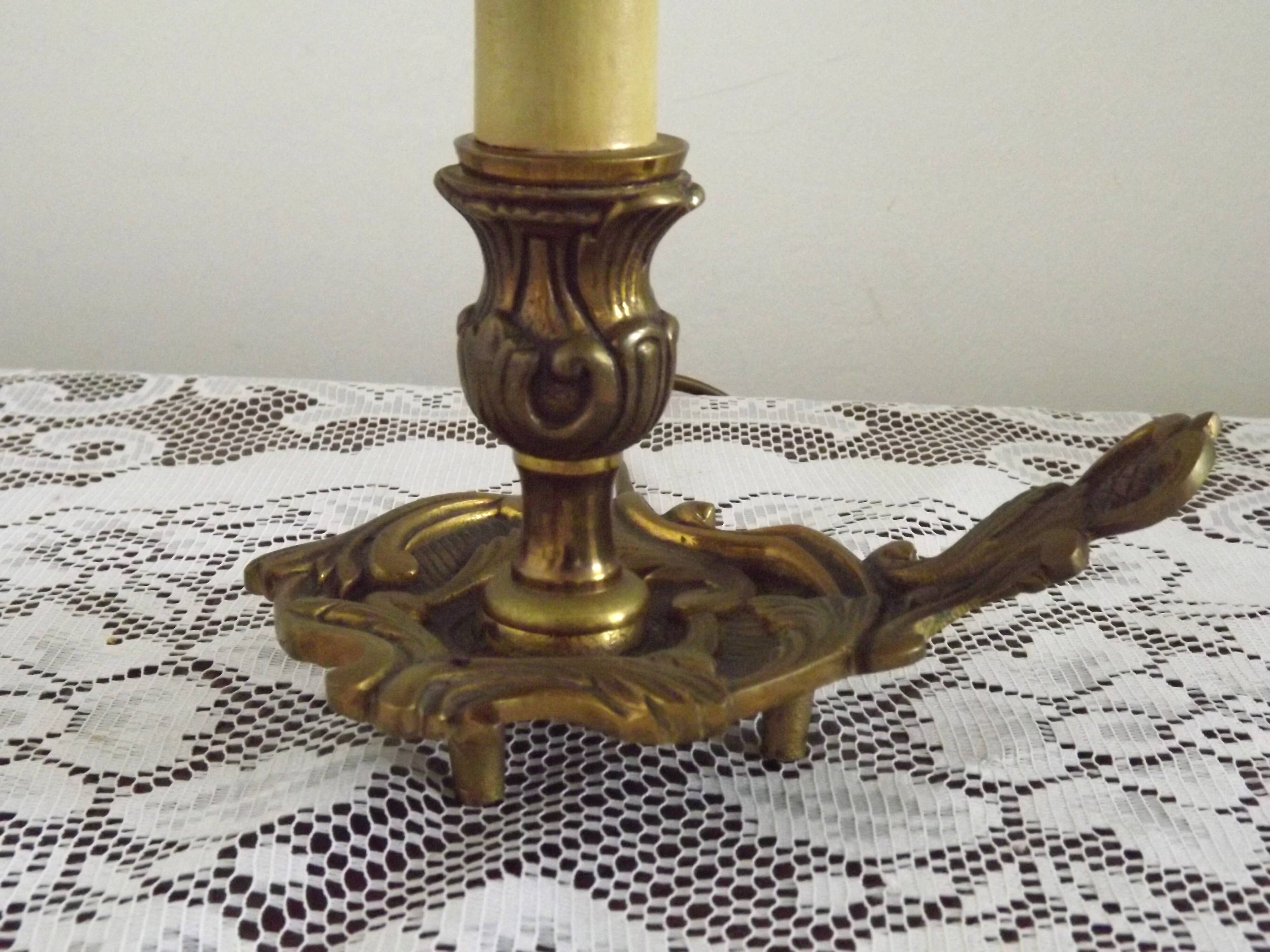 Vintage French bronze Wee Willie Winkie style lamp with red card shade.