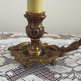 Vintage French bronze Wee Willie Winkie style lamp with red card shade.