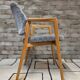 Vintage armchair from the 60s/70s in wood and grey fabric – with armrests.