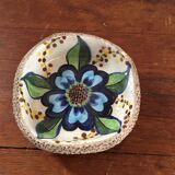 Cup lava foam with blue flower.