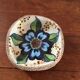 Cup lava foam with blue flower.
