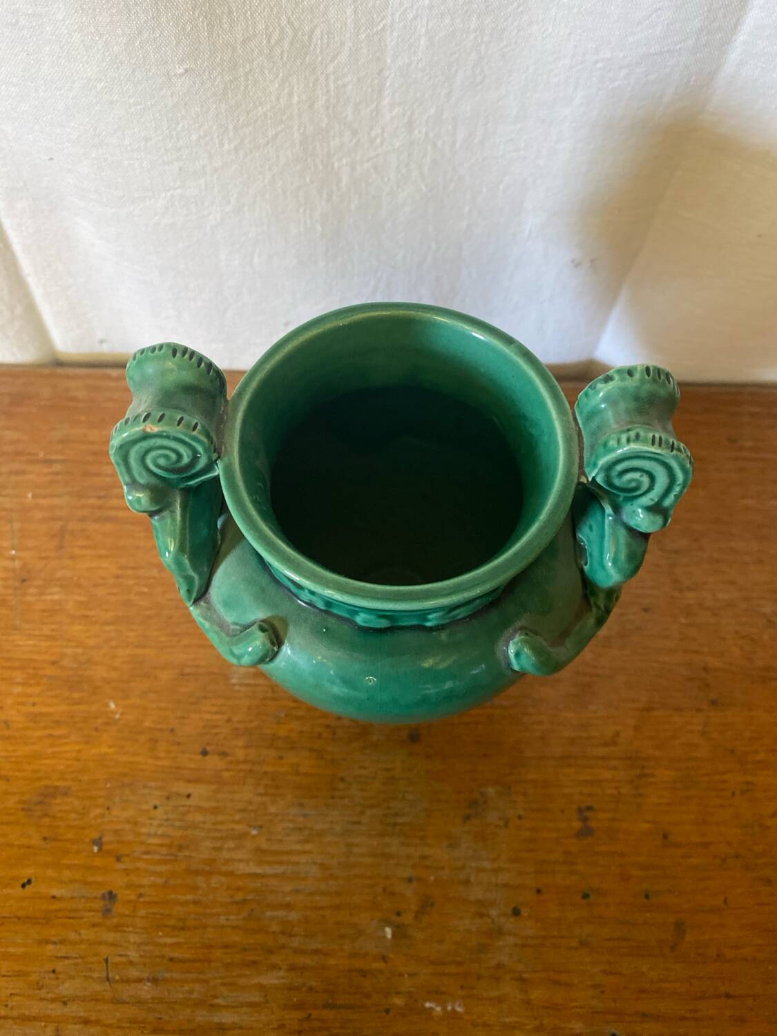 Antique green ceramic vase with handles