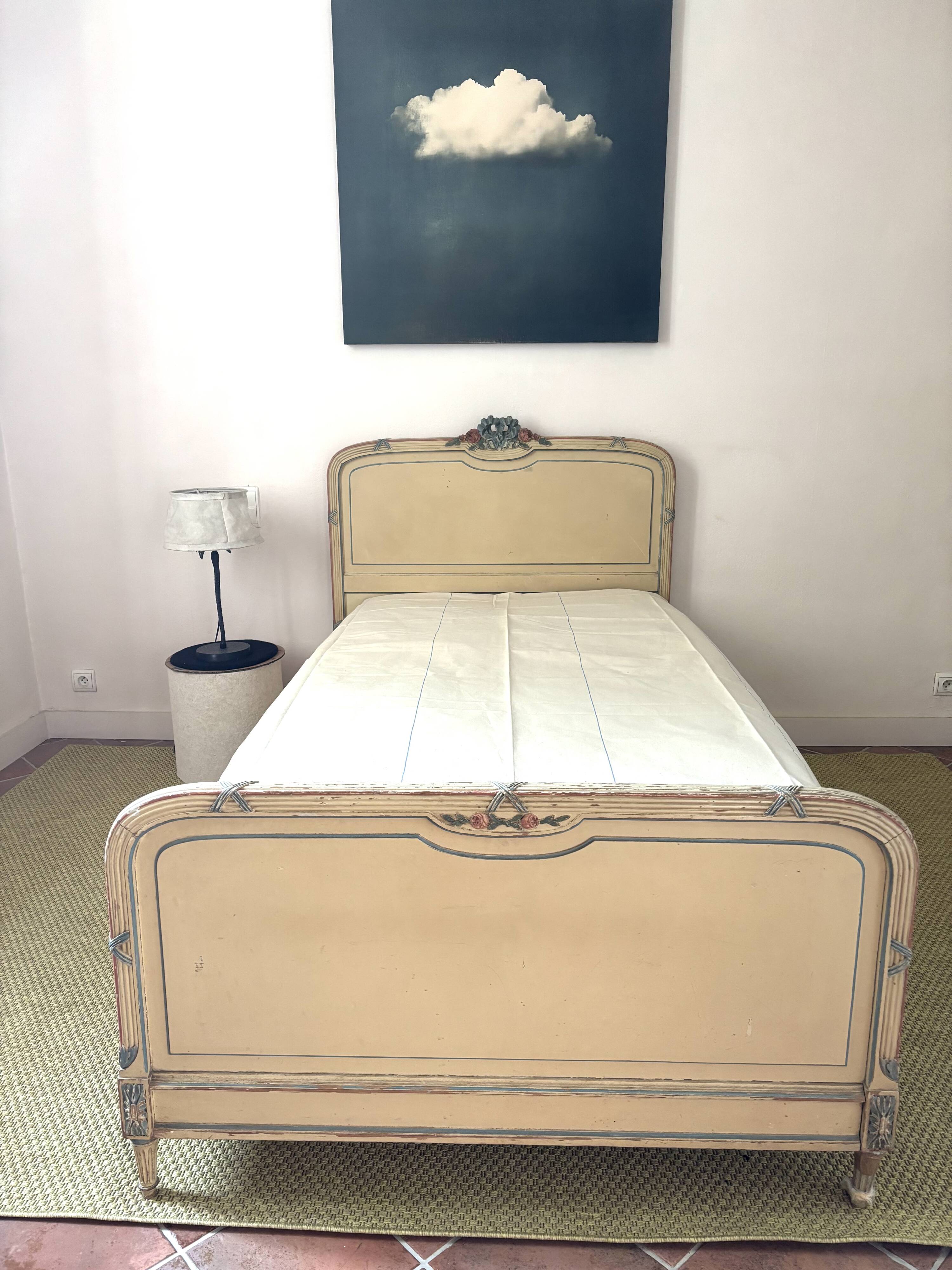 Carved and painted wooden bed