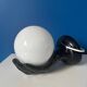 Vintage wall sconce with black hand and white opaline glass globe, 1970s L