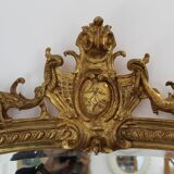 Large 19th-century wooden and gilt-studded mirror decorated with a cornucopia motif.