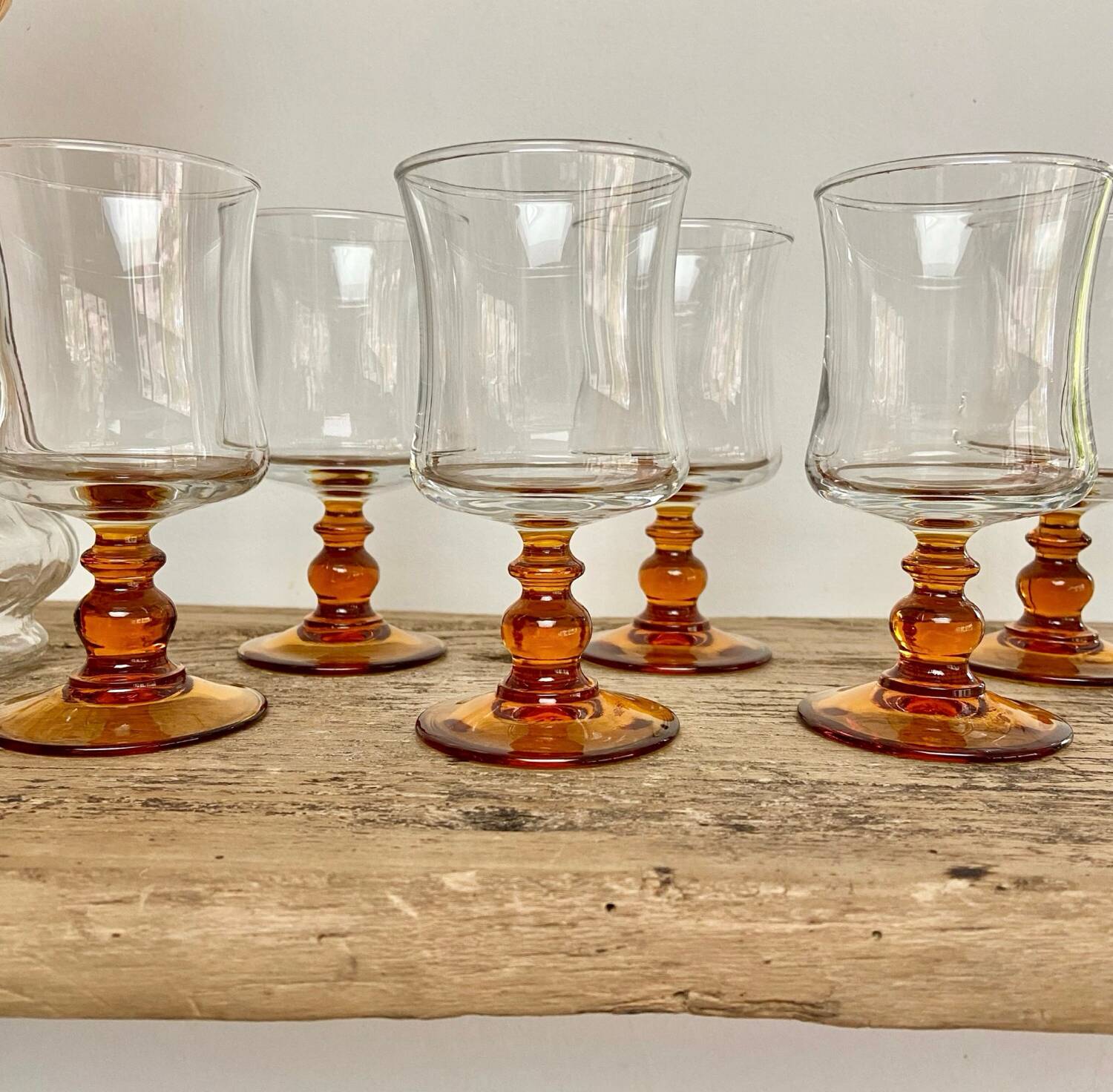 6 small amber stemmed glasses