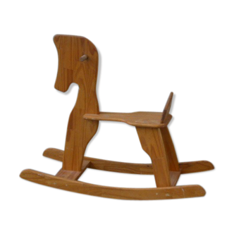 Horse rocking in pine