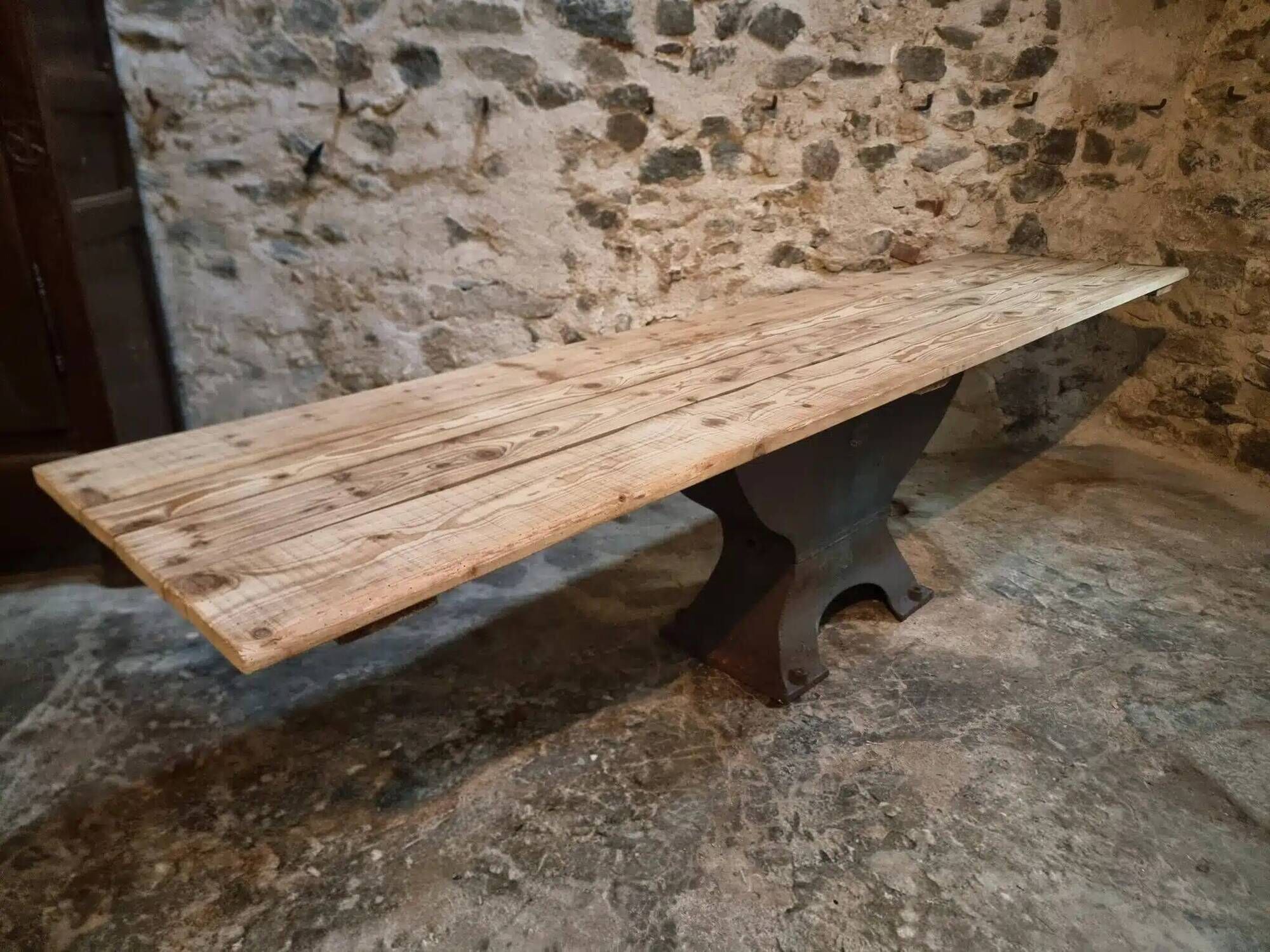Old French industrial table with a cast iron base and a pine top.