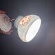 Vintage wall sconce with blue opaline glass shade and floral decorations