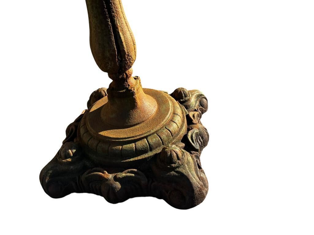 Antique cast iron garden table with decorative openwork top.