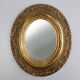 French Baroque style oval mirror in gilded wood with floral decorations