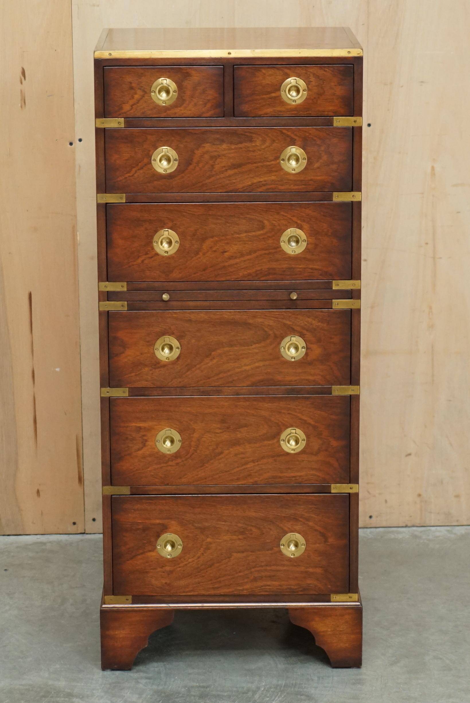 Pair of vintage military campaign high chests of drawers with leather tops.
