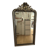 Napoleon III mirror with a pediment featuring black and gold dragons and birds.