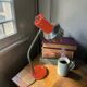Vintage orange desk lamp with chrome accents.