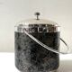Vintage chrome metal ice bucket with black marbled design, 1970s style.
