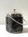 Vintage chrome metal ice bucket with black marbled design, 1970s style.