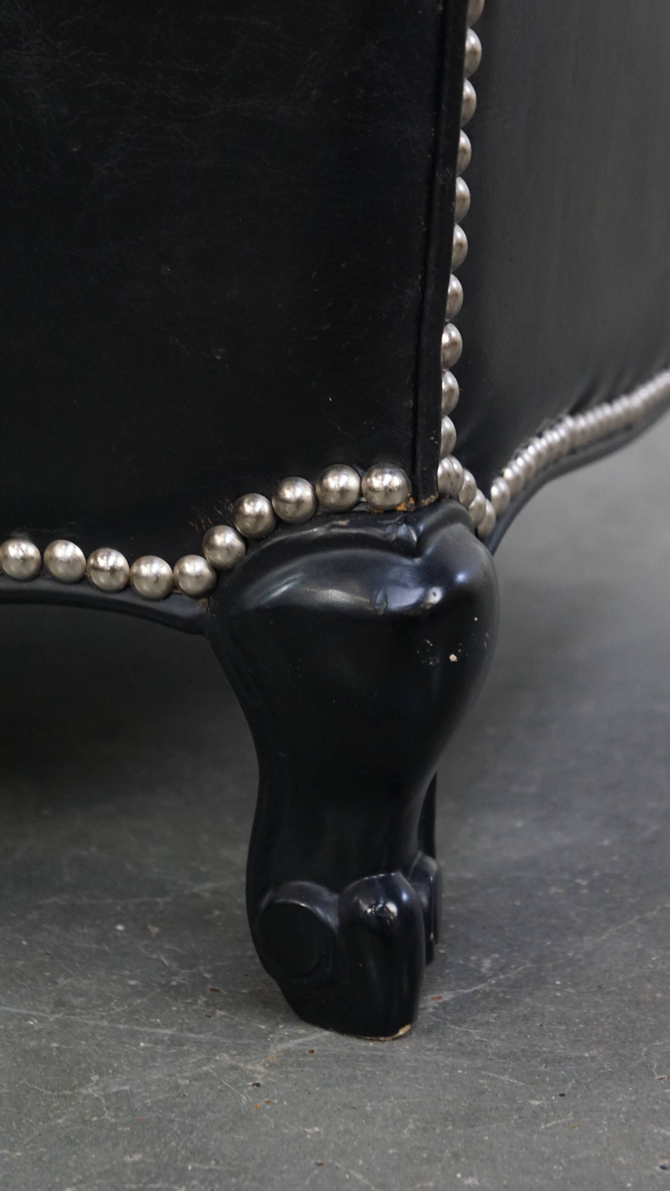 Armchair in black grained cowhide leather with a deep seat