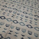 Handmade white and blue rug made of natural wool