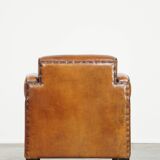 Sheepskin Art Deco design armchair with beautiful wooden details and black piping