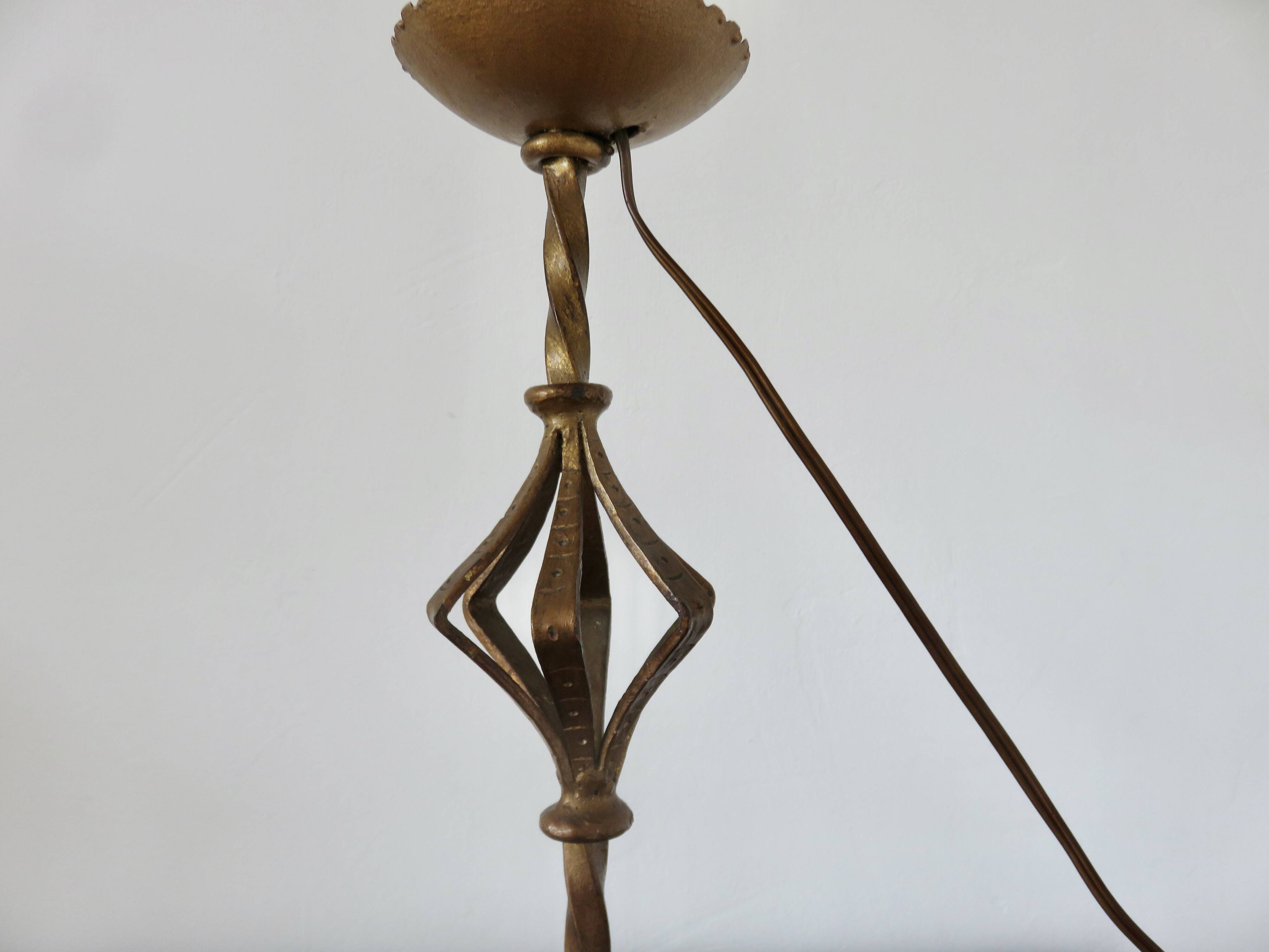 Large "Arts & Crafts" style lamp in beaten iron with a golden patina.