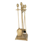 Brass fireplace tools in the style of Maison Baguès.
