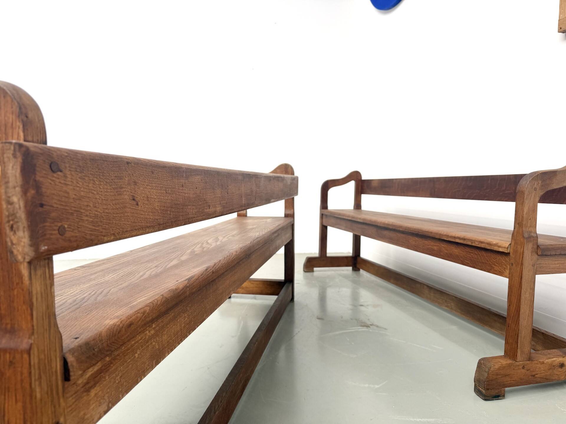 Pair of communal benches in solid oak, 1950s.