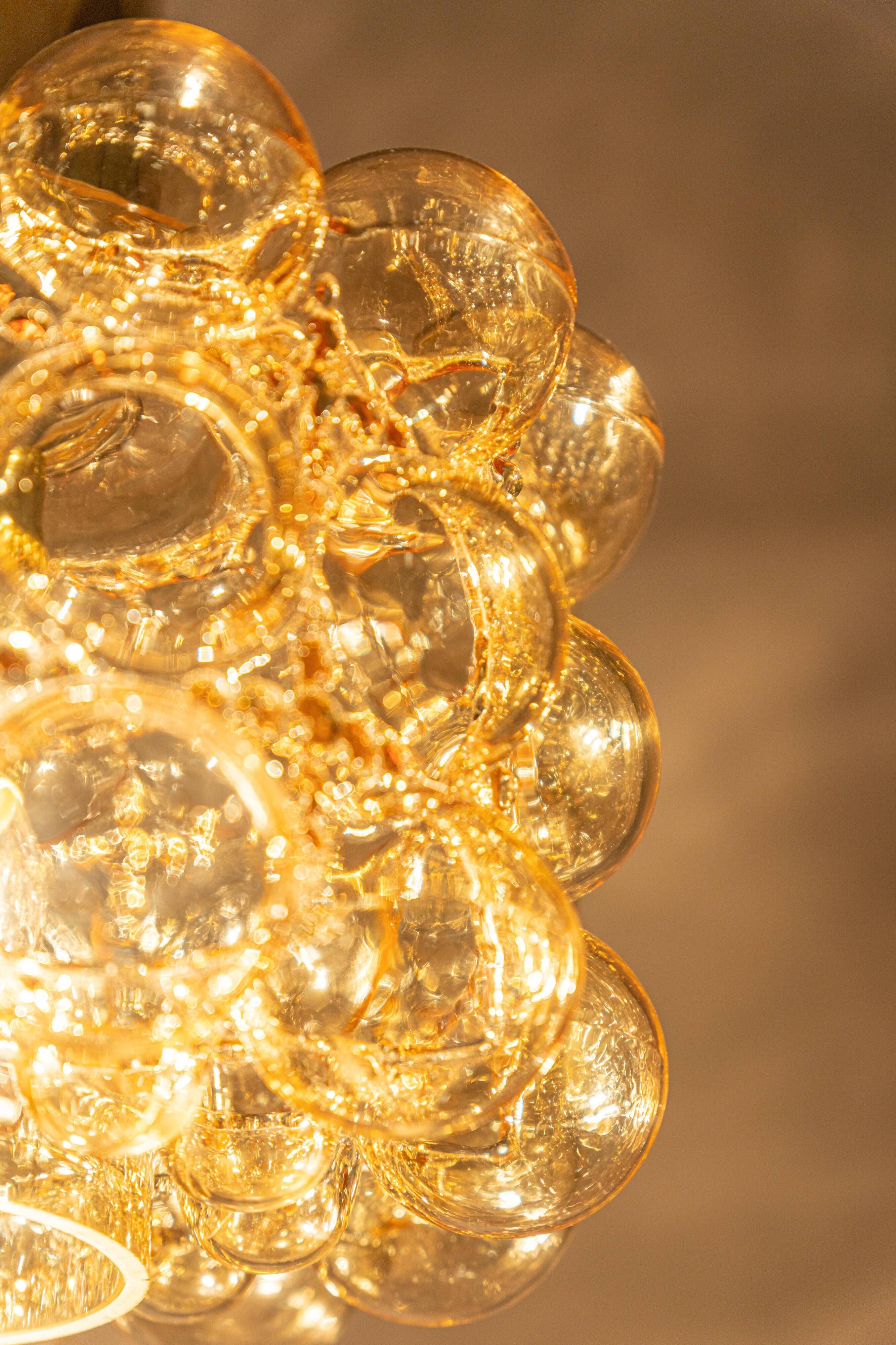 Large amber bubble glass pendant by Helena Tynell for Limburg, Germany, 1970s.