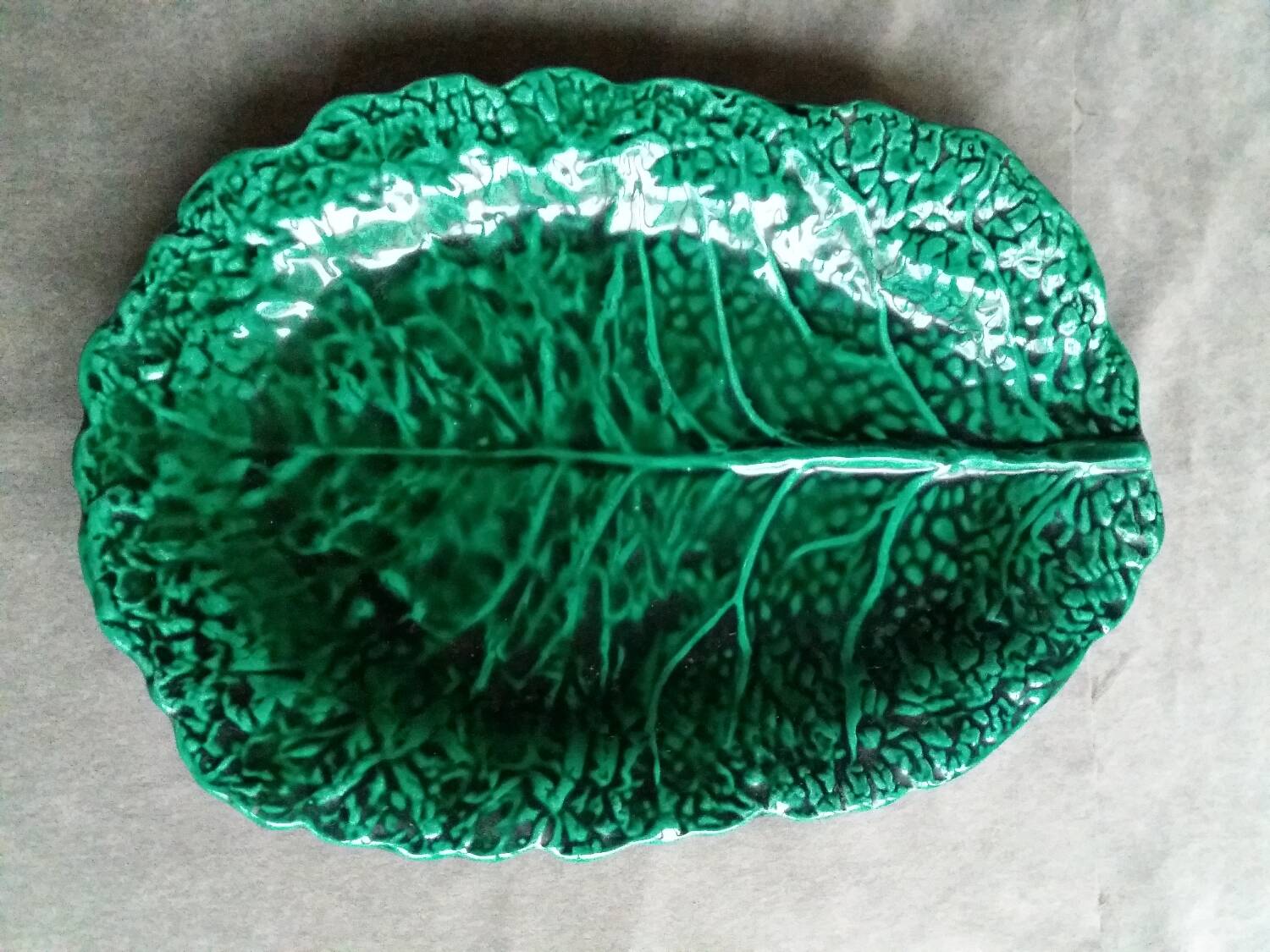 Large dish in green cabbage leaf slip