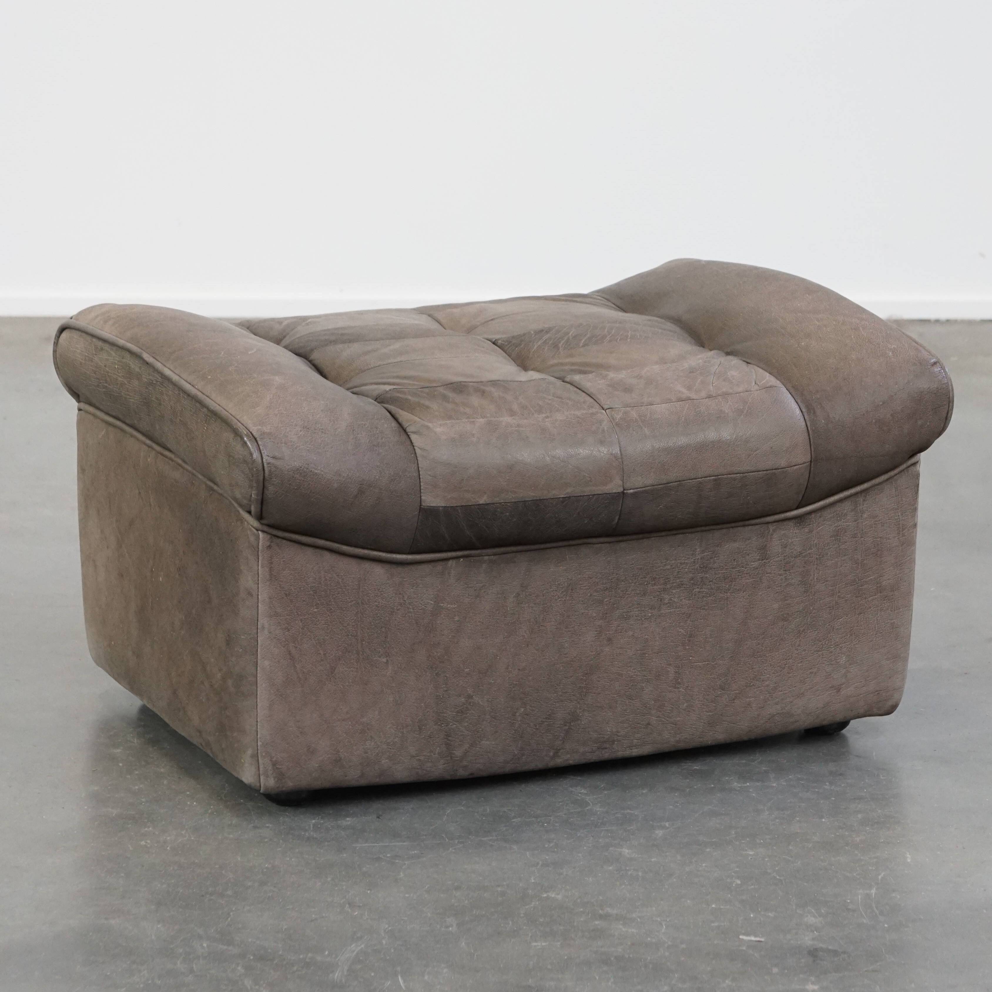 Luxurious, comfortable, gray leather vintage footstool