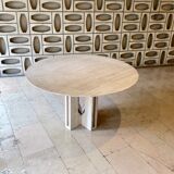 Round travertine dining table with double cross foot