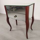 Glass art deco mirror beside table