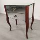 Glass art deco mirror beside table