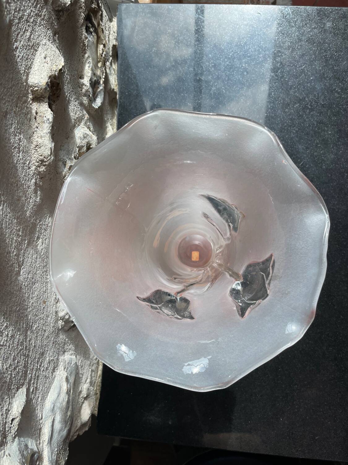 Pink glass vase decorated with tulips