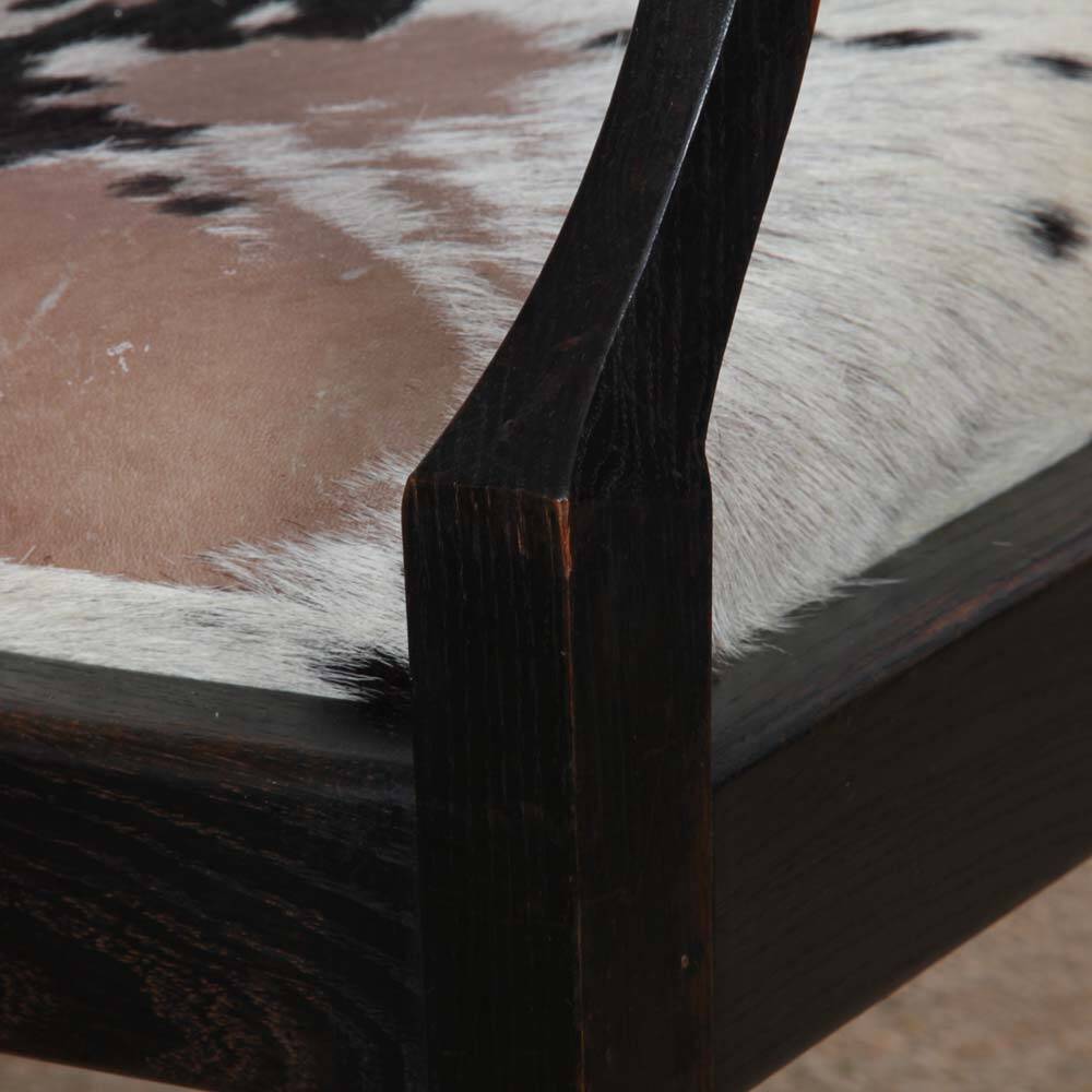 Bridge armchair in wood and leather, work from the early 20th century.