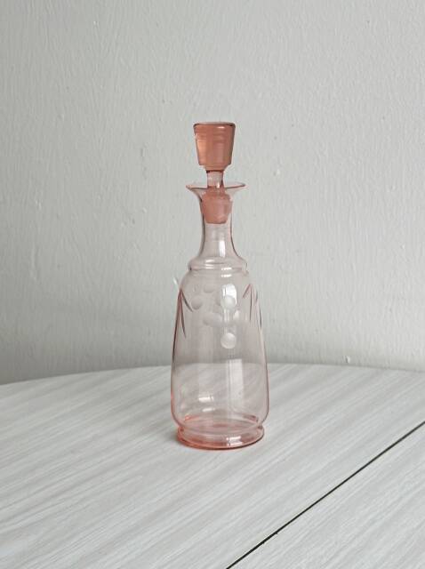Antique translucent pink glass bottle