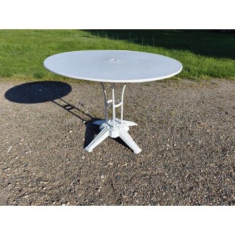 Garden table with a cast iron base and a metal top.