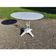 Garden table with a cast iron base and a metal top.