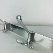 Wall-mounted coat rack, strip of 3 aluminium hooks from the 1960s.