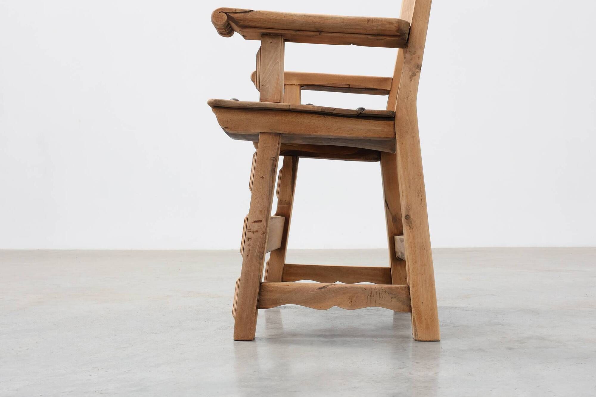 Brutalist armchair with carved rosettes and nailed wooden seat, Spain