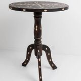 Vintage side table from the early 19th century, dark wood with mother-of-pearl inlays, oval shape with three legs, ethnic style.