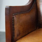 Sheepskin and wooden vintage Art Deco design armchair in a cognac color