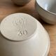 Trio of beige enamelled sandstone bowls
