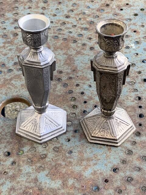 Pair of metal candlesticks, chiseled with a statuette in front, rose pattern in relief, art deco
