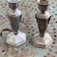 Pair of metal candlesticks, chiseled with a statuette in front, rose pattern in relief, art deco