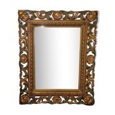 Bevelled mirror and carved wood