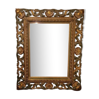 Bevelled mirror and carved wood