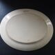 Large antique plate stamped with a fauna and flora pattern.