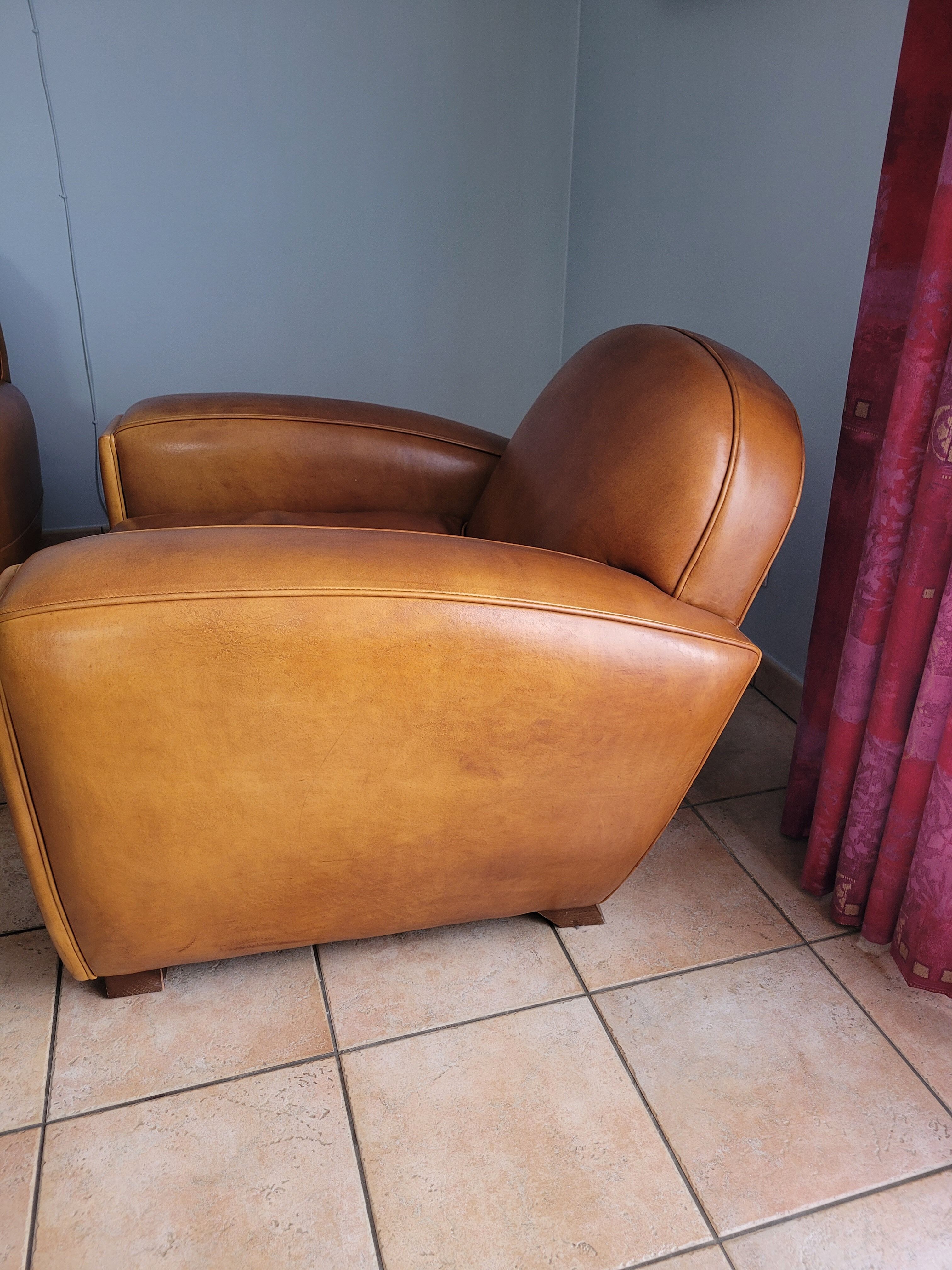 Leather club armchair and its pouf