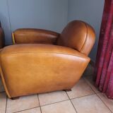Leather club armchair and its pouf