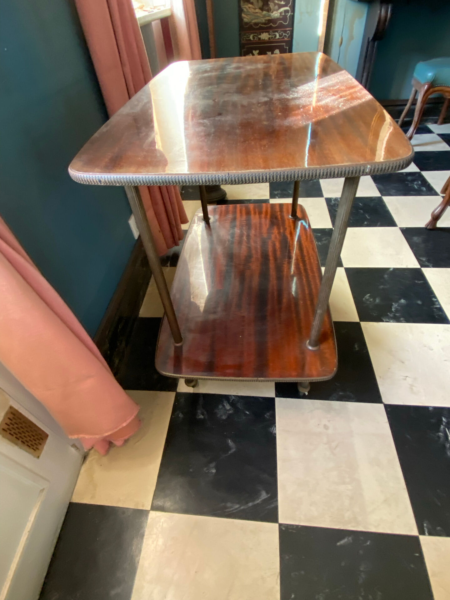 Elegant vintage serving trolley on wheels, two wooden shelves.